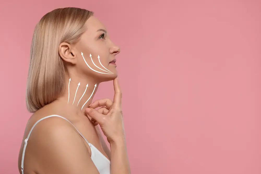 woman touching her chin with facelift graphics illustrating on her face