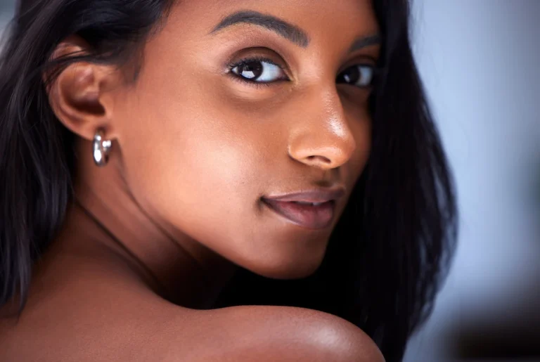 woman looking over shoulder with beautiful natural nose
